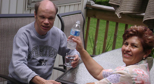 Man and woman enjoying water on their patio